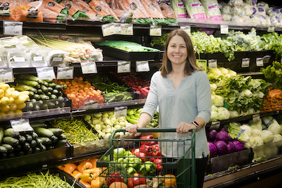 Tina shopping in the produce section of the market